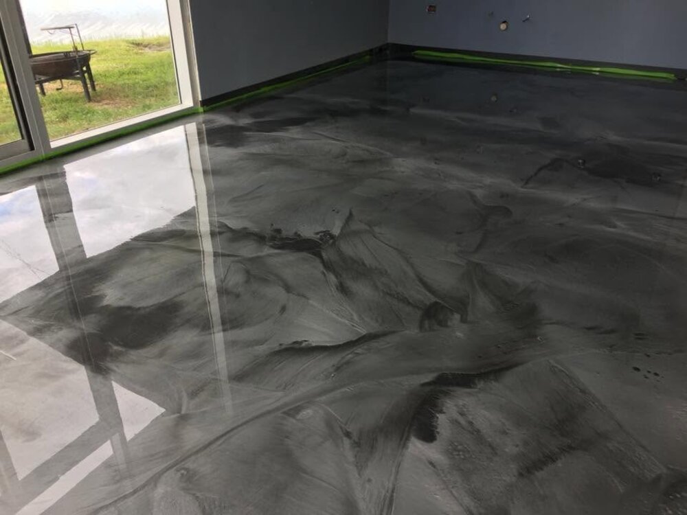 Charcoal metallic epoxy floor with sliding glass door