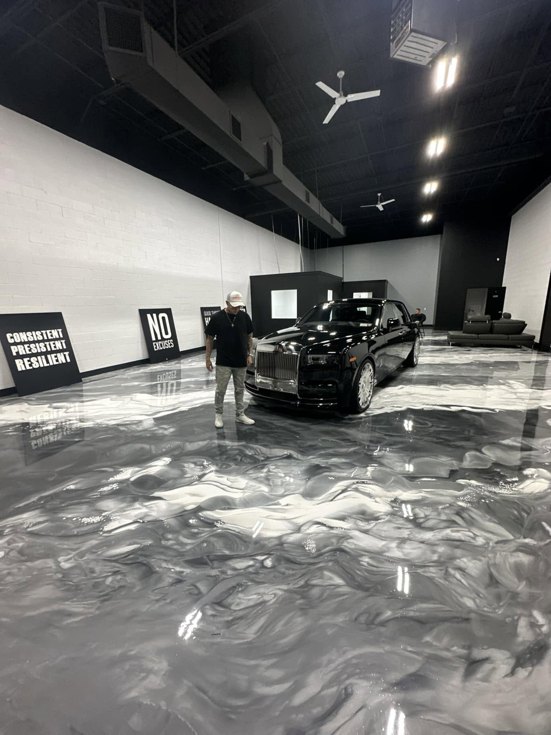 Rolls Royce on a custom metallic epoxy showroom floor by Excellent Epoxy